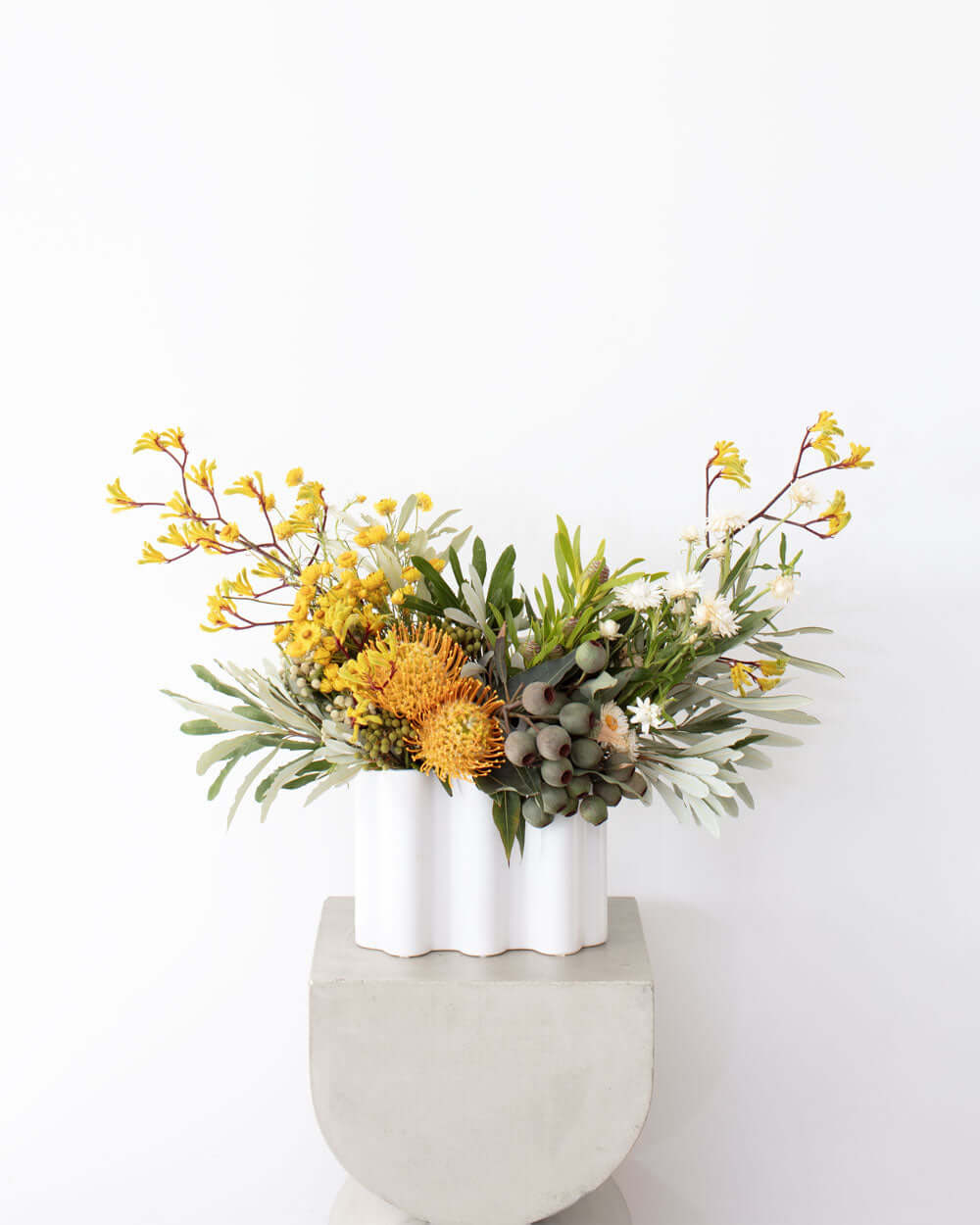 Designing Flowers in A Vase Workshop showcasing a beautiful floral arrangement in a modern white vase.