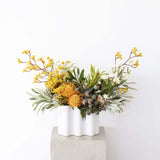 Designing Flowers in A Vase Workshop showcasing a beautiful floral arrangement in a modern white vase.