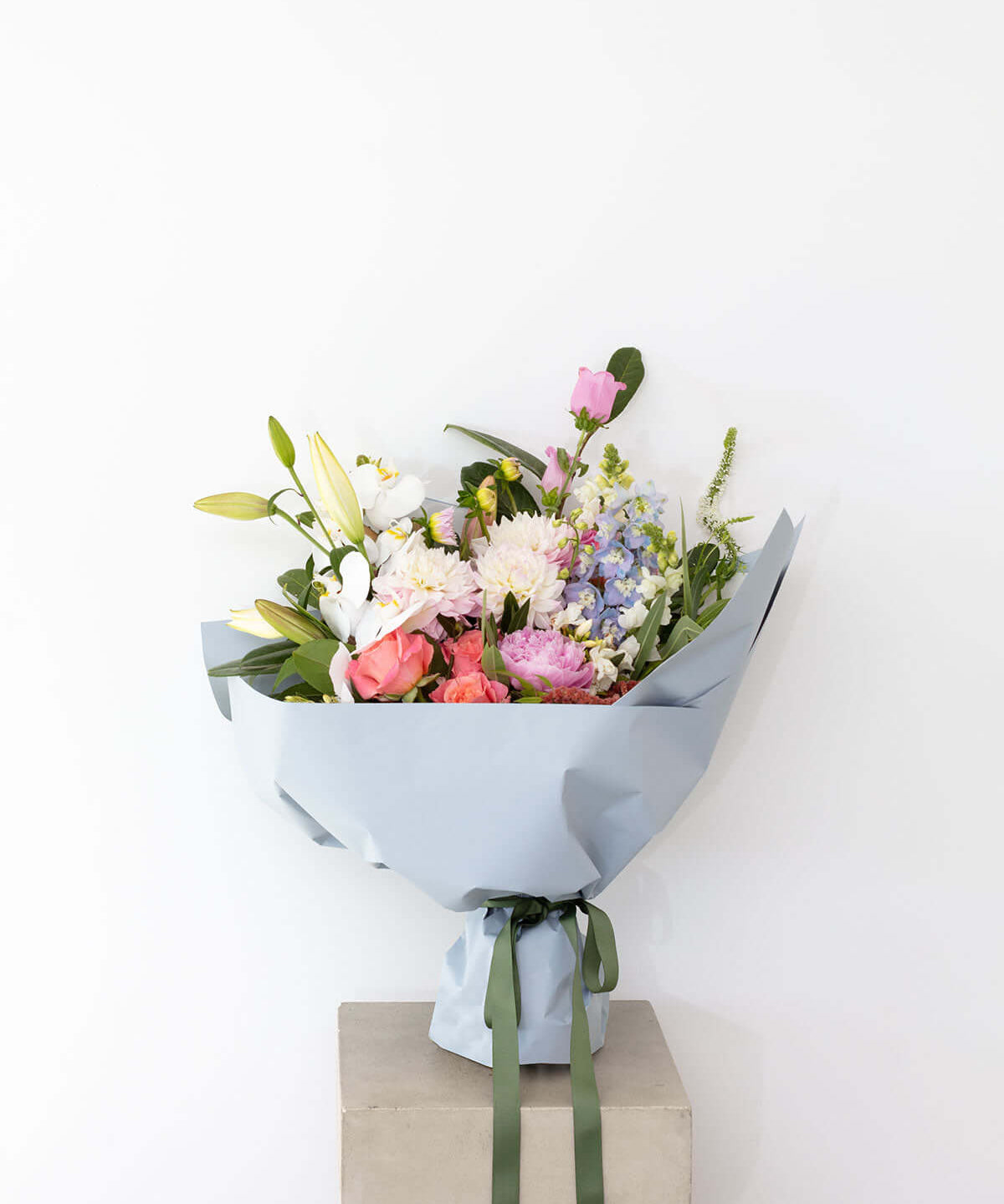 Sorbet Pastel Bouquet featuring soft and whimsical pastel flowers in blue wrapping.